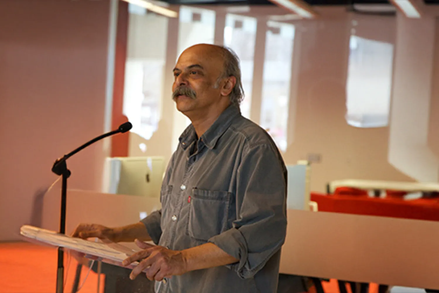 An image of Dr. Ananda Shankar Chakrabarty standing at a podium.