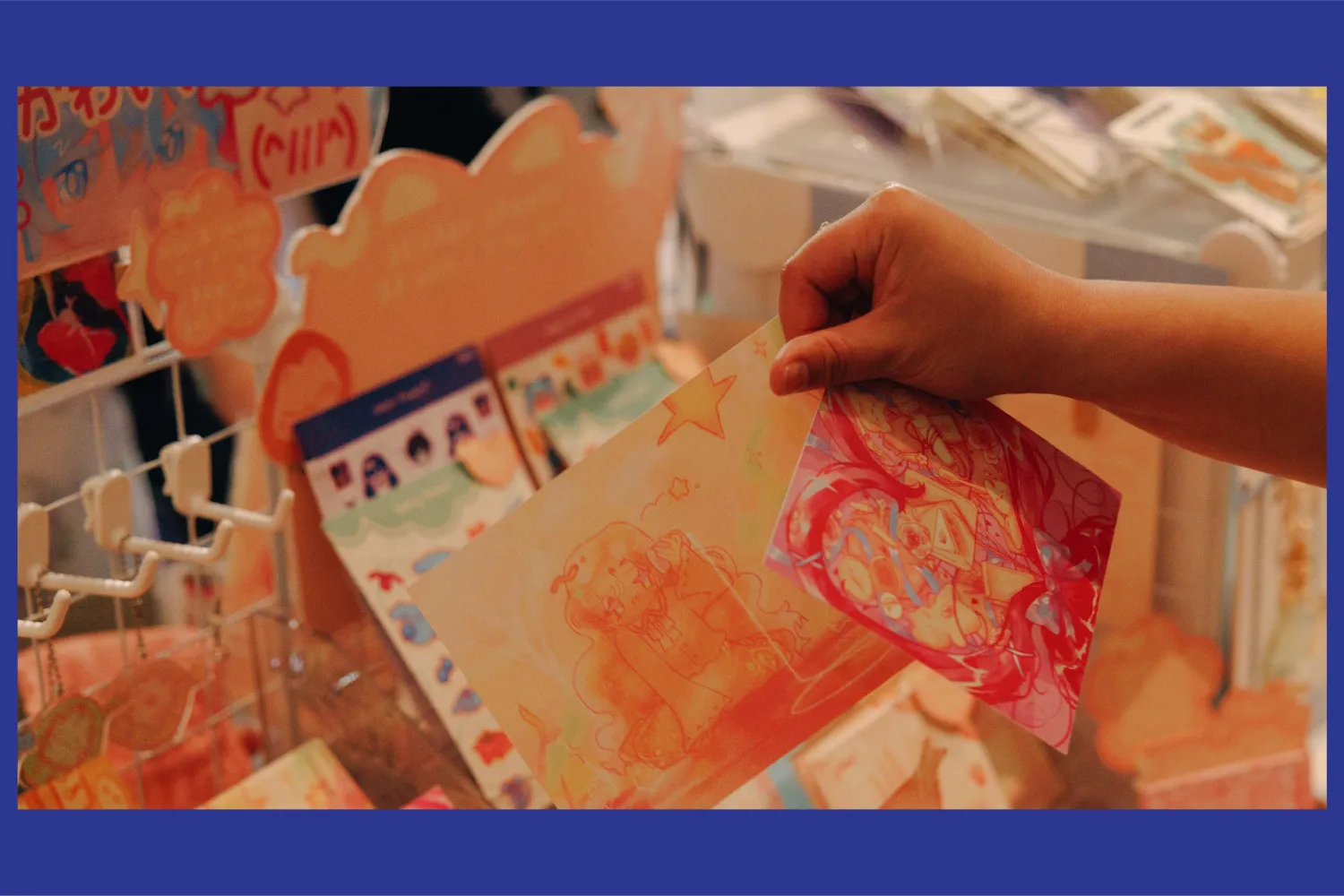 An individual holding a postcard in there hand at a tabeling event.