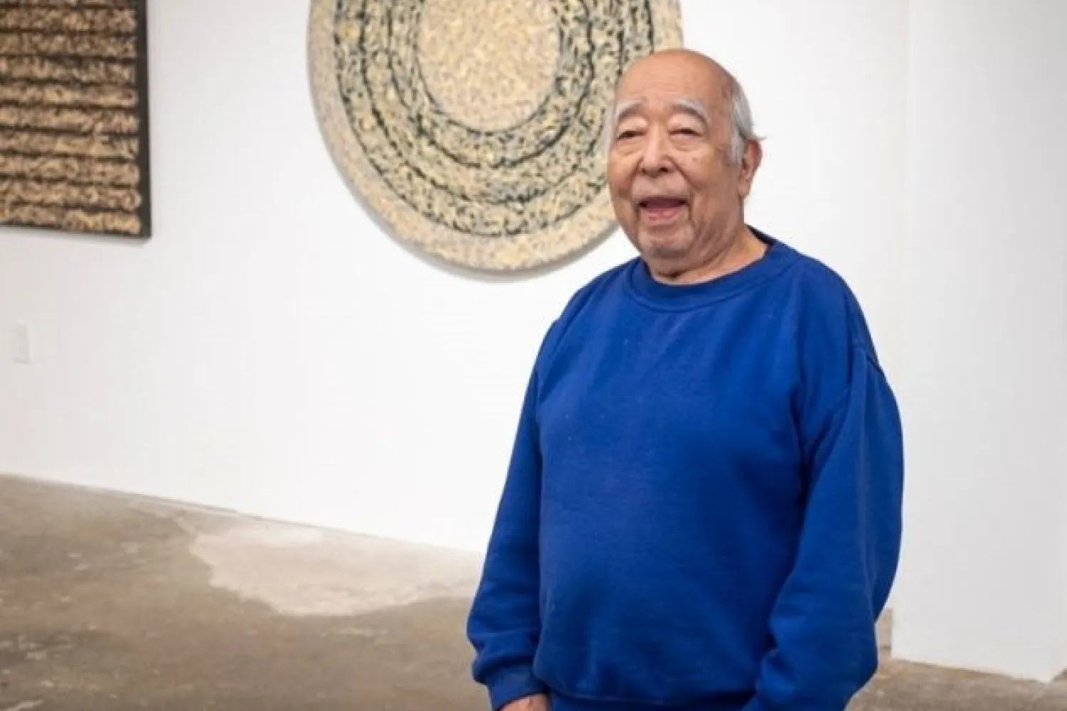 Nobuo Kubota wearing a blue sweater. 