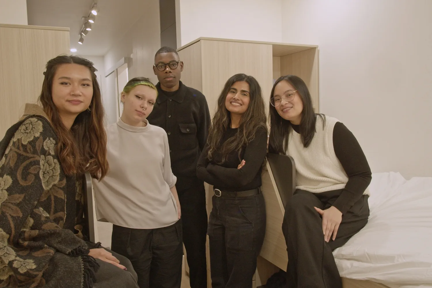 Design students standing in experimental housing unit