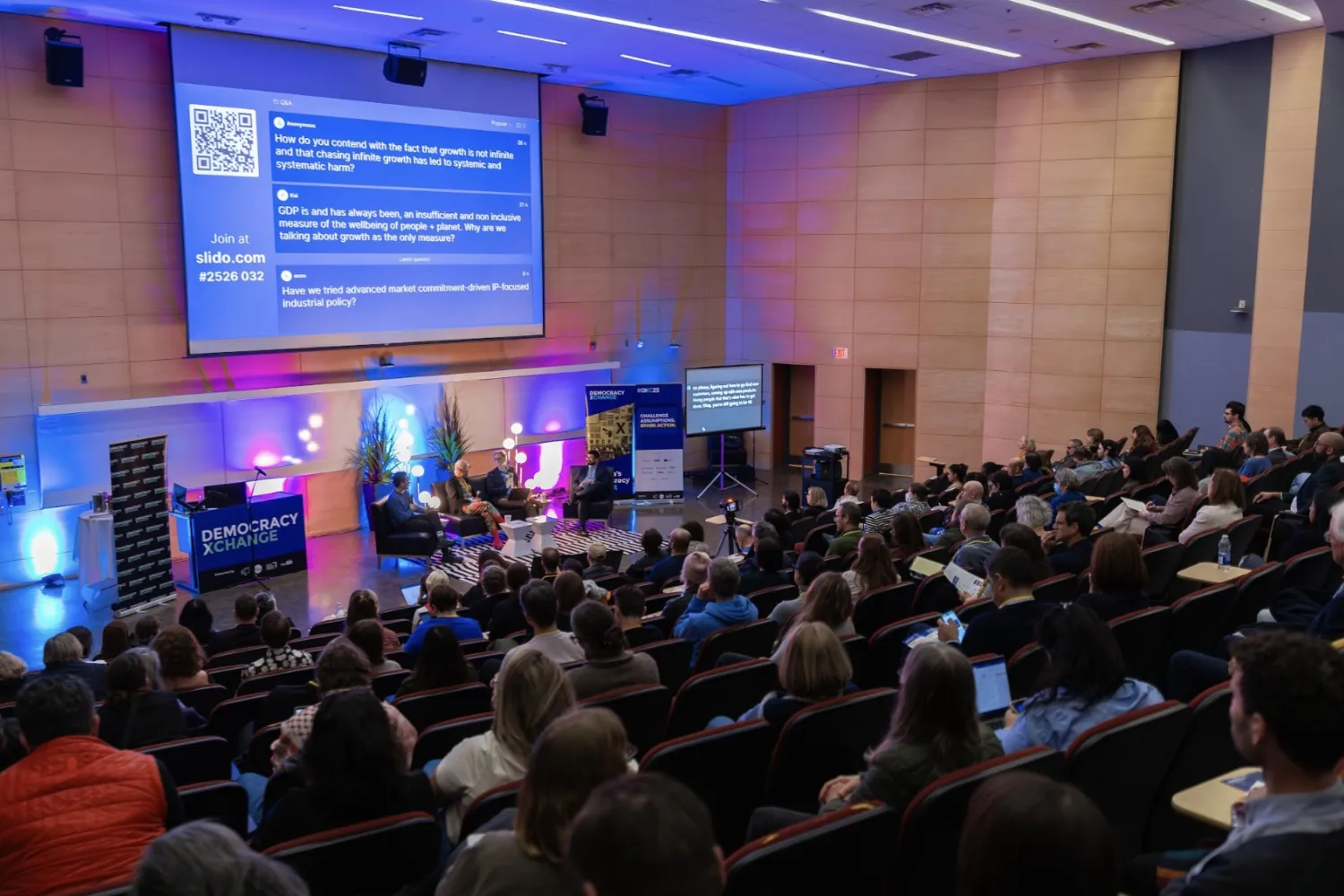 Audience members sitting in an auditorium at a presentation. 