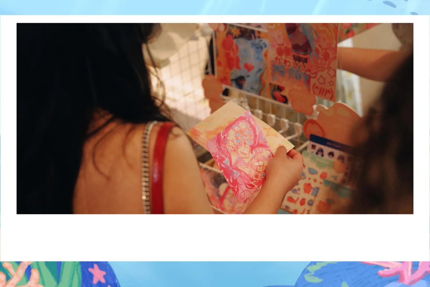 Individual holding an illustrated postcard.