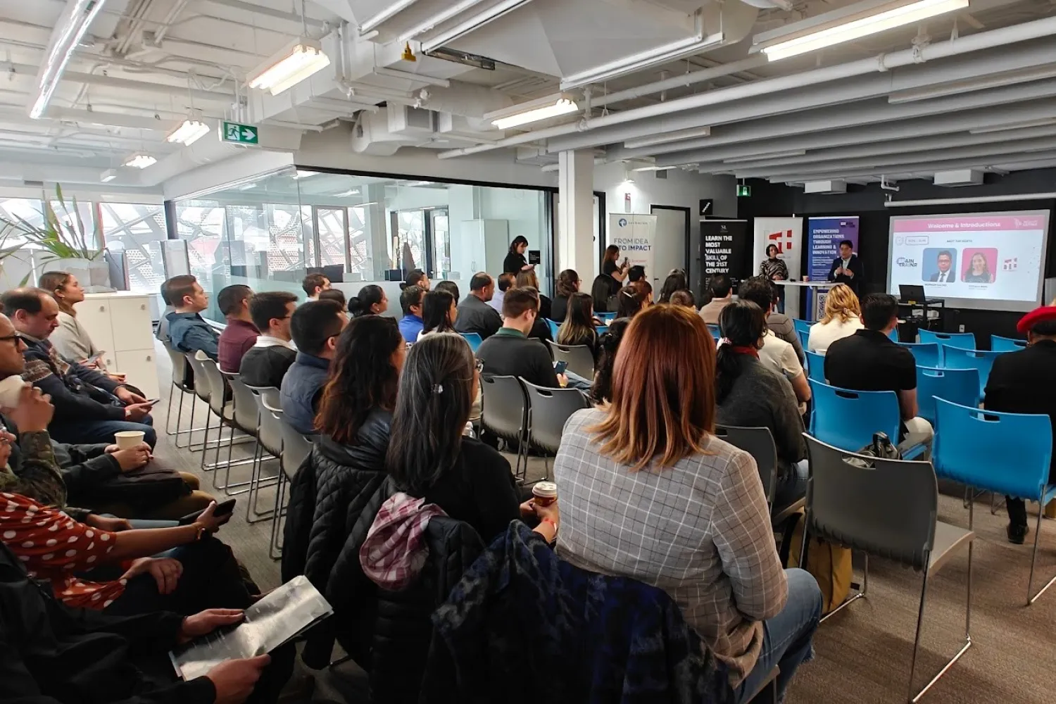 People sitting in an audience at a presentation. 