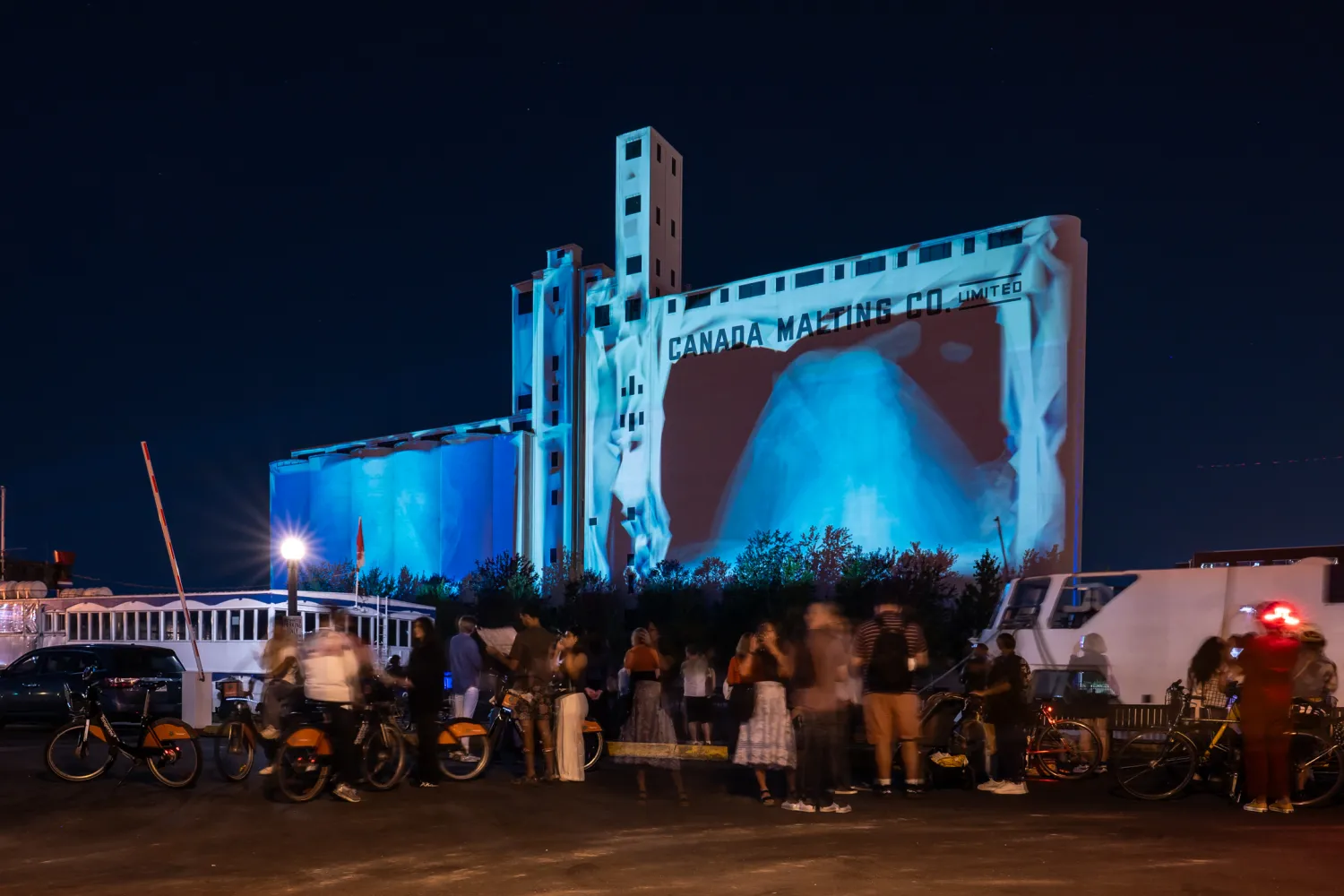 Crowd watching projection on Canada Malting Silos