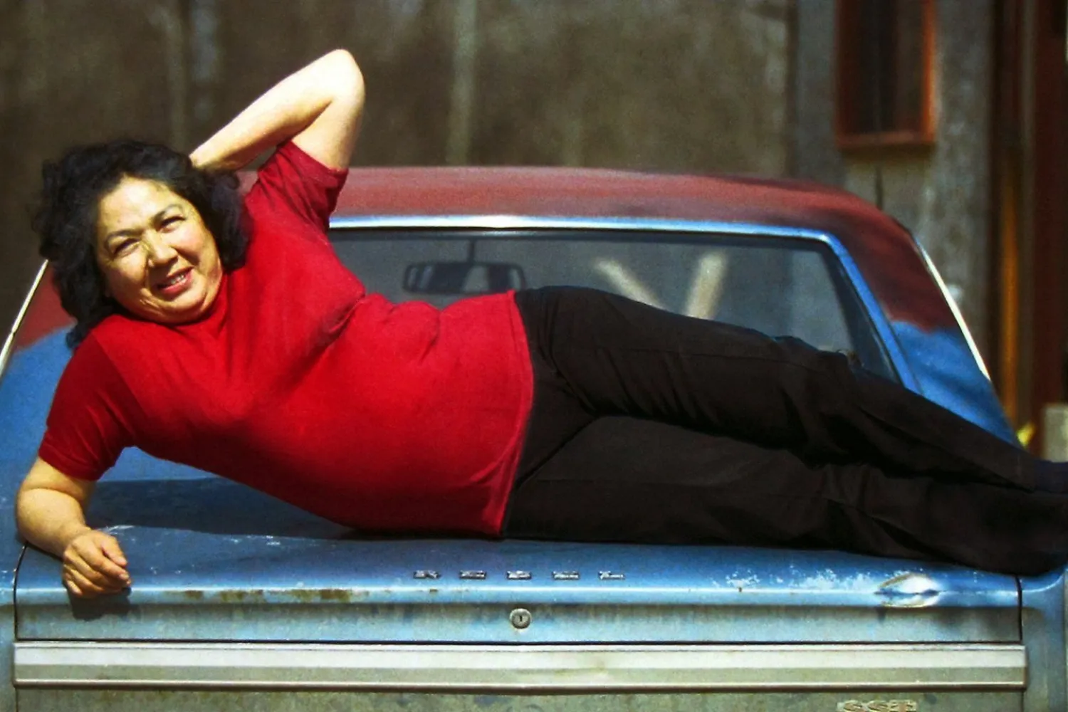 Woman in red t-shirt on a car