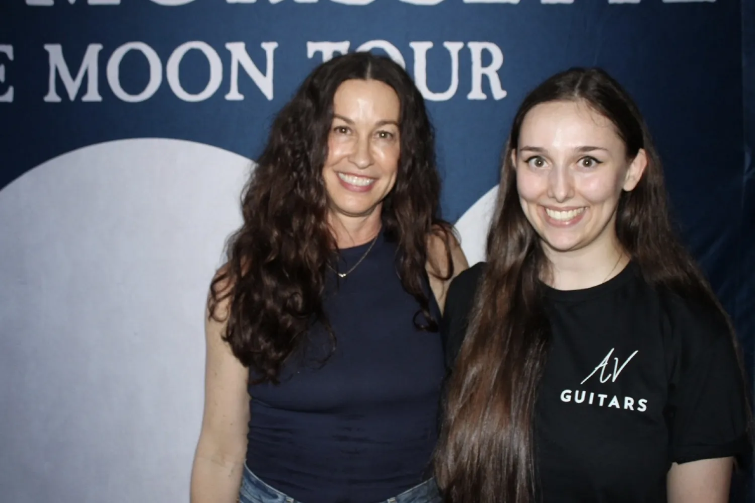 Two people posing for a photo at a meet and greet