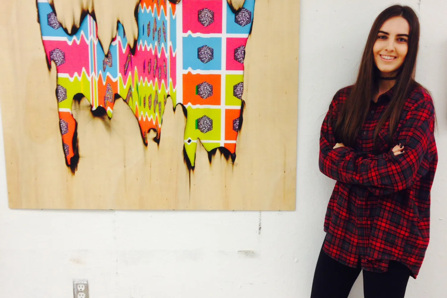 Person posing in front of their painting
