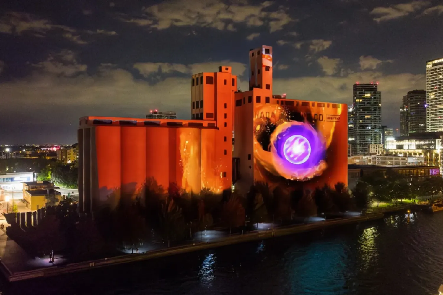Image projected on Canada Malting Silos, orange with a purple circle at the right