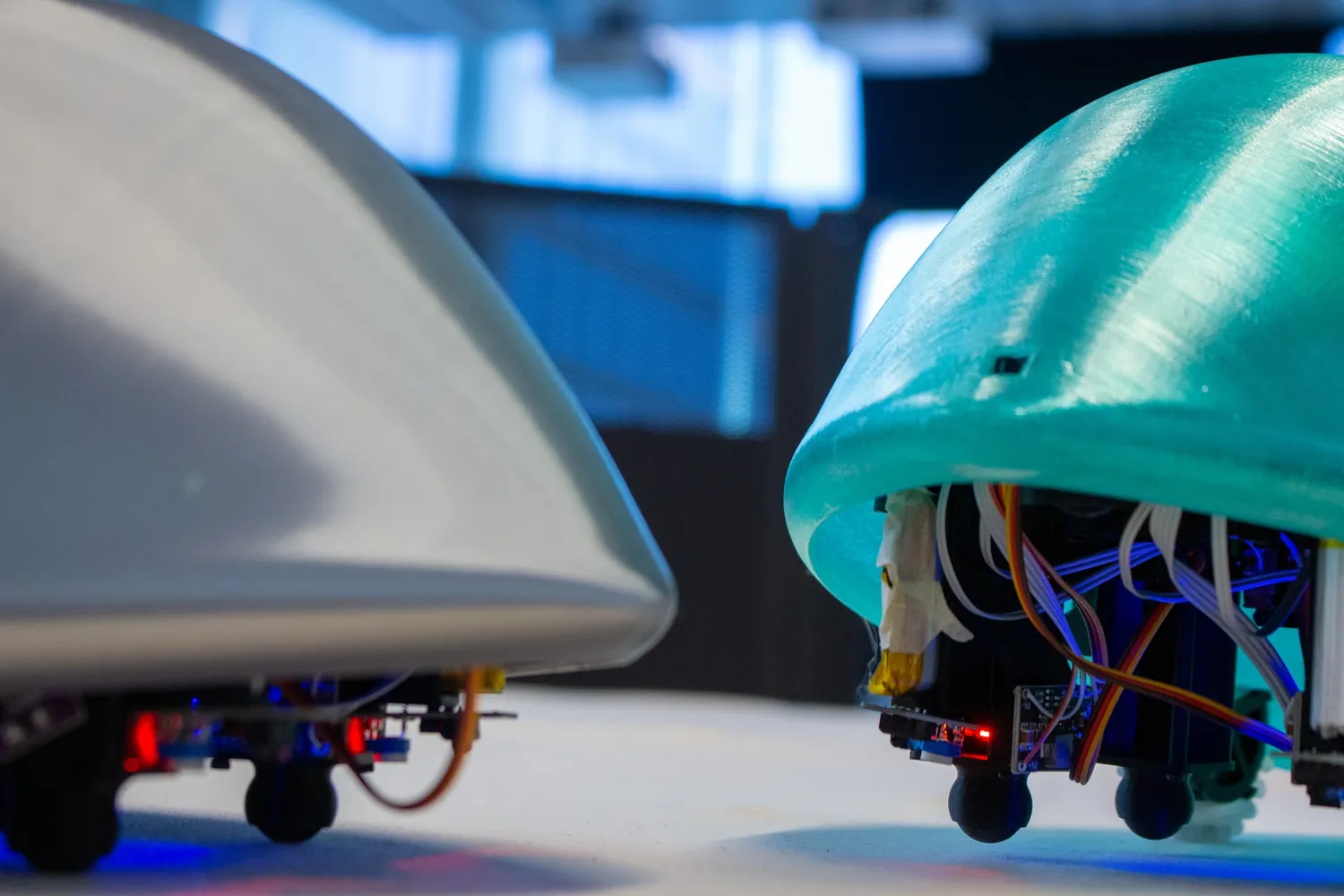 Image of two machines, left grey shell looking machine, at right, green domed machine with electrical wires