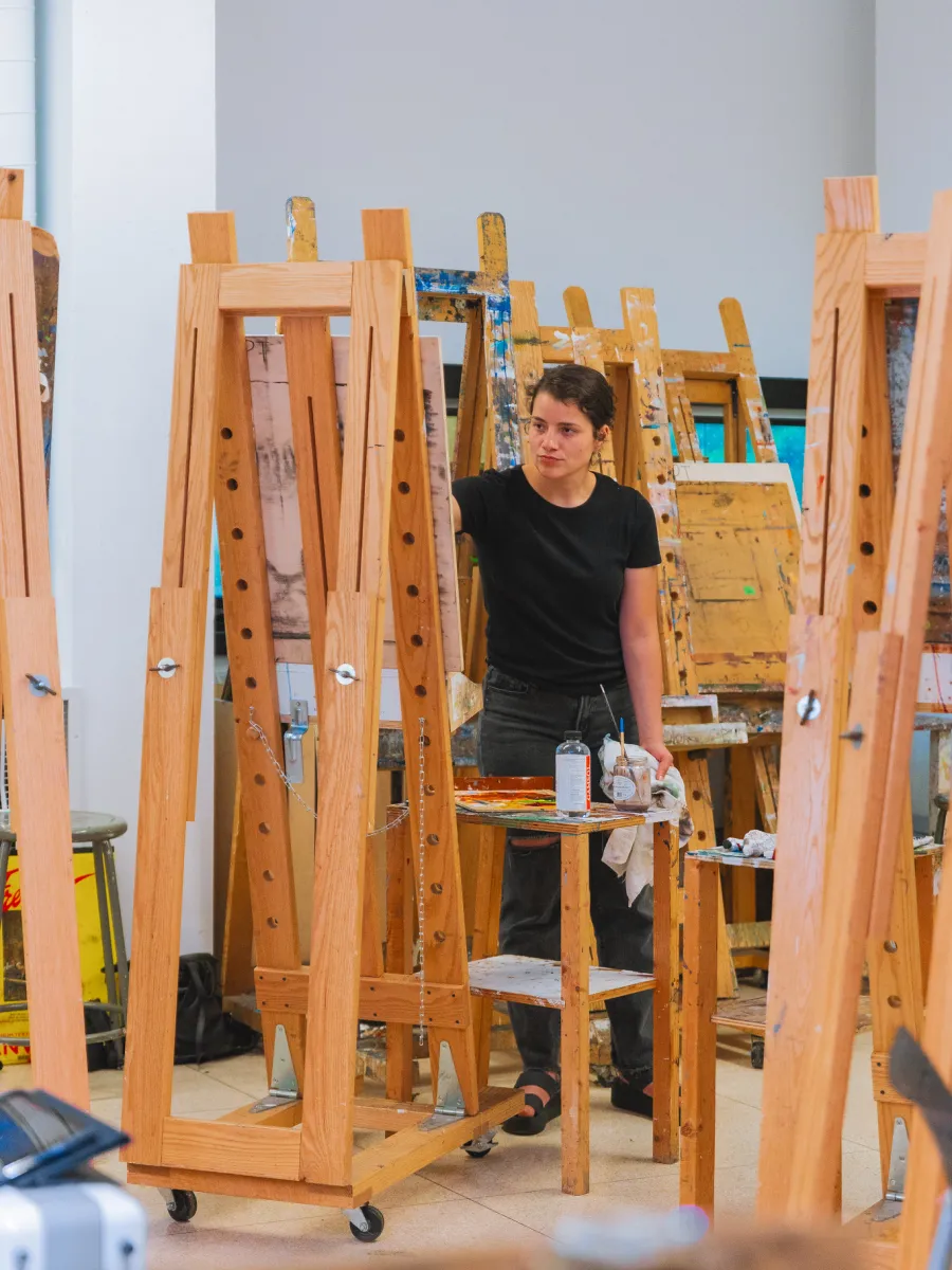 Student painting at an easel