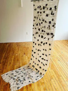 Fabric hanging from the ceiling with black accents