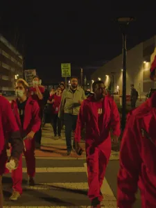 A group of black man wearing red outfit walked the evening urban set