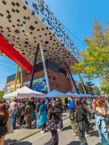Welcome Day on McCaul St with people visiting booths and the Sharp Centre in the background.