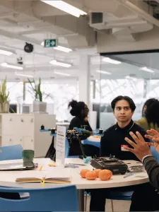 Students discussing their ideas with mentor.