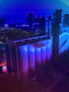 Photo of Canada Malting Siloes, a heritage building located at Toronto's Waterfront, overlayed with a blue, purple and pink gradient.