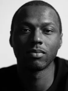 A man with short hair and black t-shirt