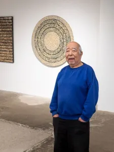 Nobuo Kubota wearing a blue sweater. 