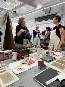 Two people standing in front of each other in the Sustainable Colour Lab