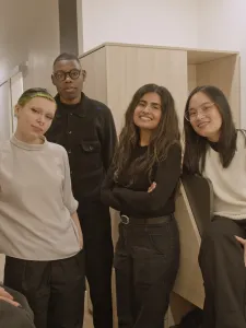 Design students standing in experimental housing unit