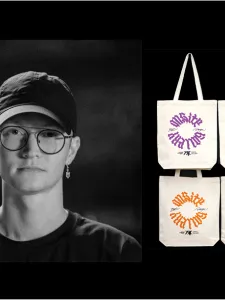 a man with glasses and hat. on the right, 4 tote bags