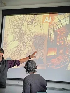 Professor pointing to a screen of two images