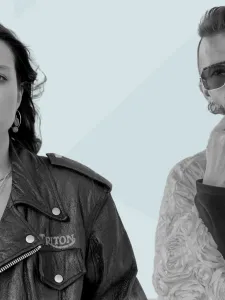 A woman wearing a black jacket and a man wearing sunglasses and fur coat.