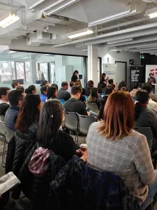 People sitting in an audience at a presentation. 