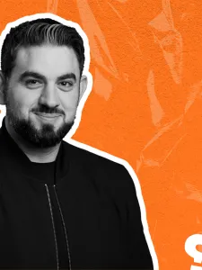 Orange background with black and white headshot of Daniel Francavilla and hashtag, x and question mark icons in foreground