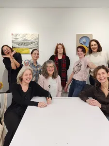 Students gathers in front of gallery wall