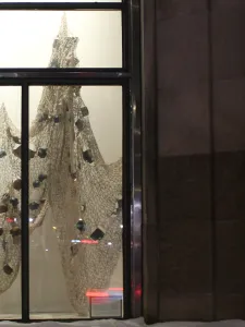Textile based artwork on display behind gallery window