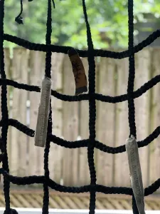 Intertwining rope forming squares with hanging cards with words