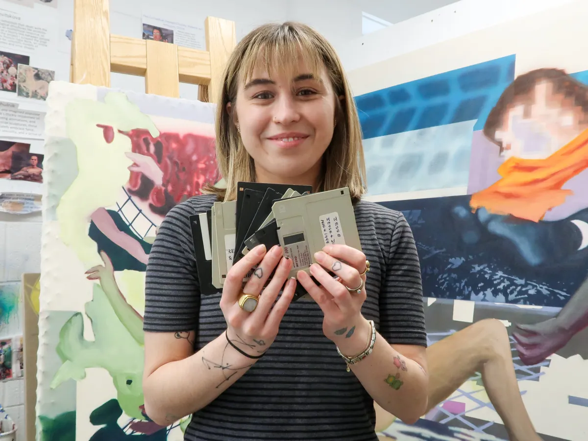 Student holdind floppy discs