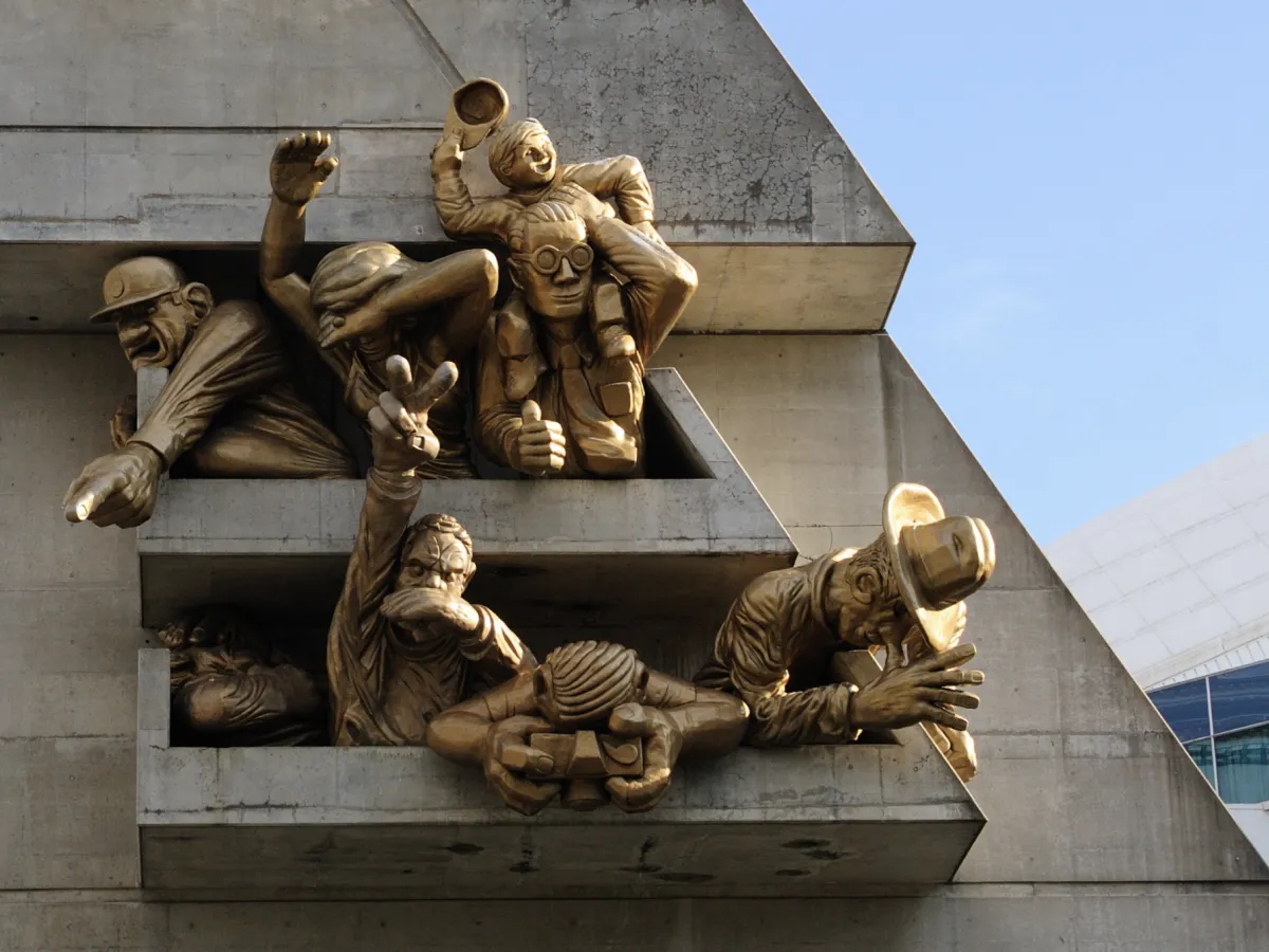 Bronze statues on the side of a building