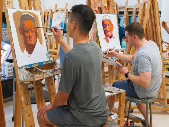 Student painting in a studio