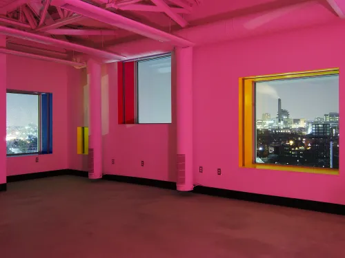 Interior of the Sharp Center, with walls drenched in pink lights