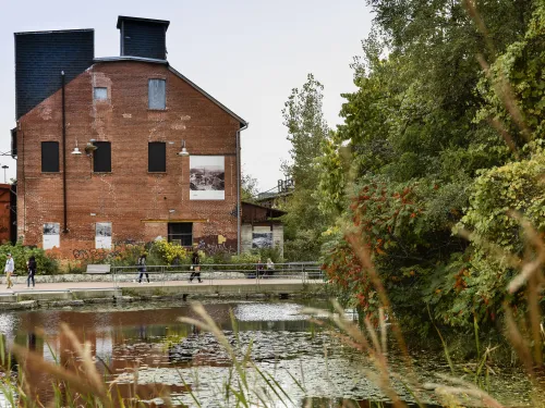 Brick building in front of a poind