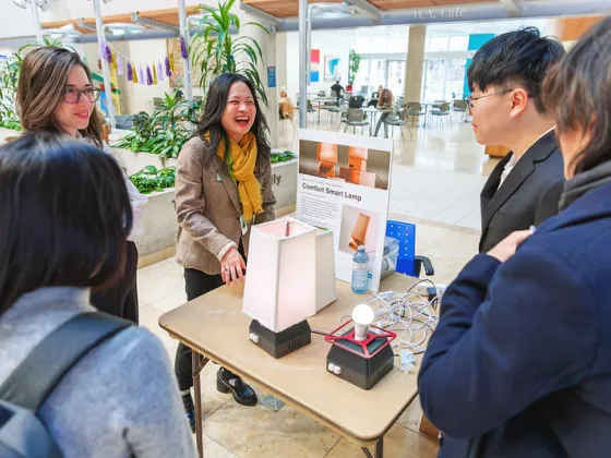 Ranee Lee and students examine a product. 