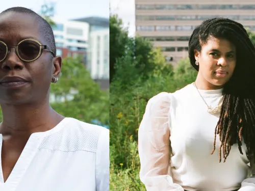 Two women: on the left a woman with short hair, wearing sunglasses and white shirt. One the left a woman with long dreadlocks and cream colored sweater.