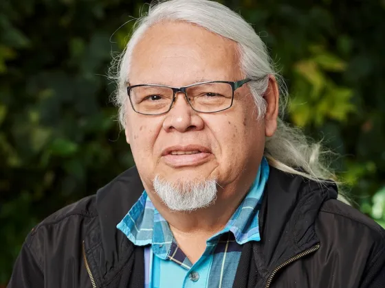 Photo of Rick Hill Sr, wearing glasses with white hair and short beard