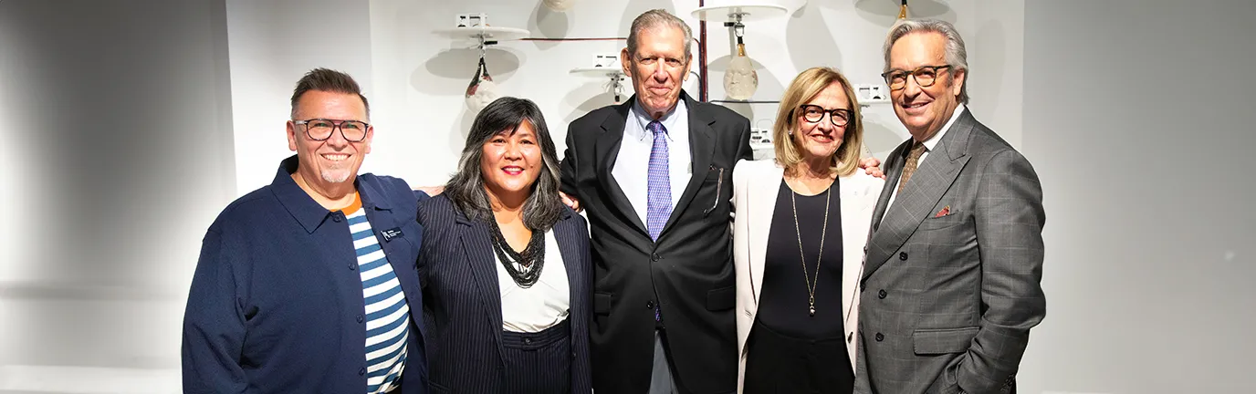 Group posing for photo at art exhibit