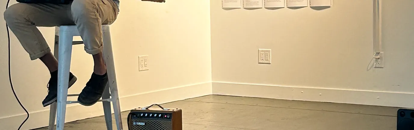 Man playing a guitar in an art gallery