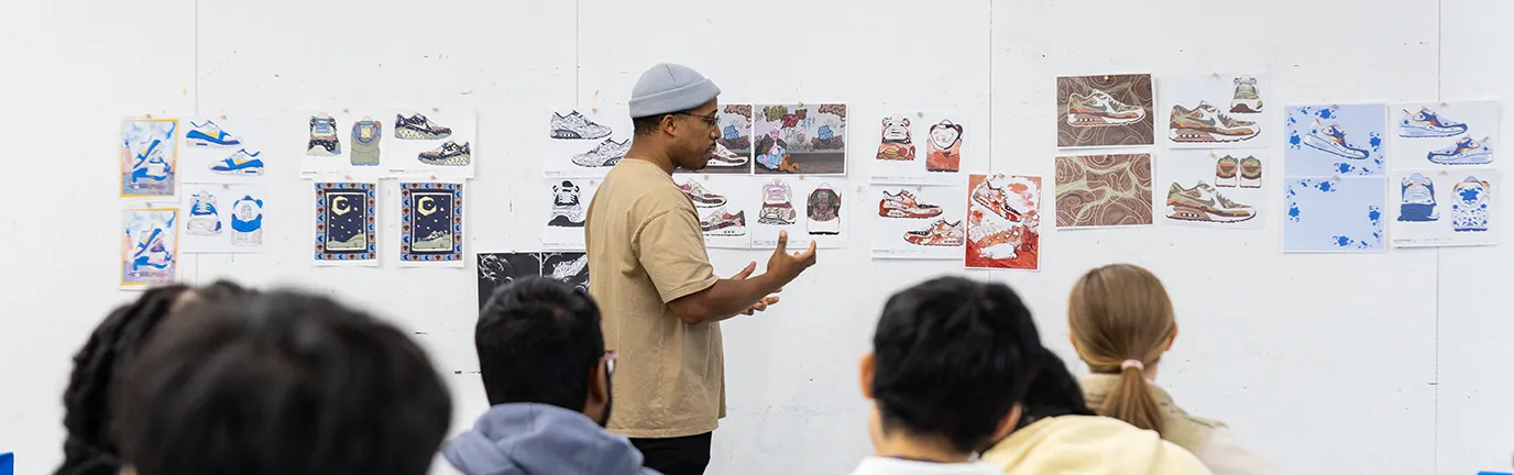 Person presenting their work on a gallery wall