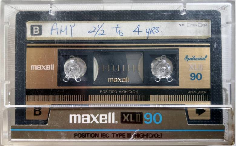 Image: Amy Wong, AMY 2 ó to 4 yrs., 2024 (detail), cassette tape audio recording. Image courtesy of the artist. Image of gold and black cassette tape, with Amy 2 1/2 to 4 years written in blue ink.