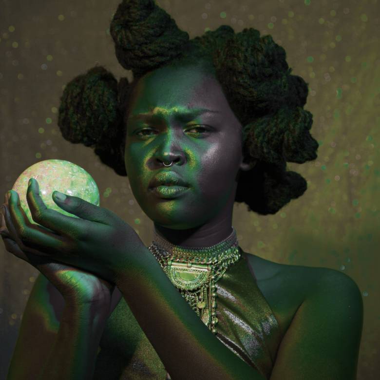 Photography of a Black woman holding a ball