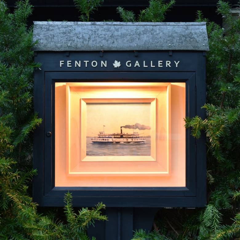 A photograph of a little art gallery with a painting inside
