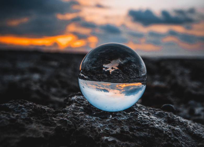 A photo of a glass ball on a nature background. 