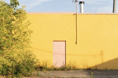 Photo of yellow wall and pink door
