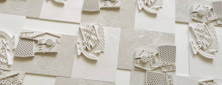 A white bas relief 3D printed sculpture.