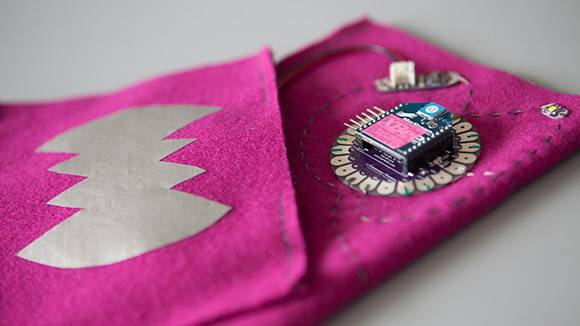 Two pieces of pink fabric with embedded technology, representative of digital futures