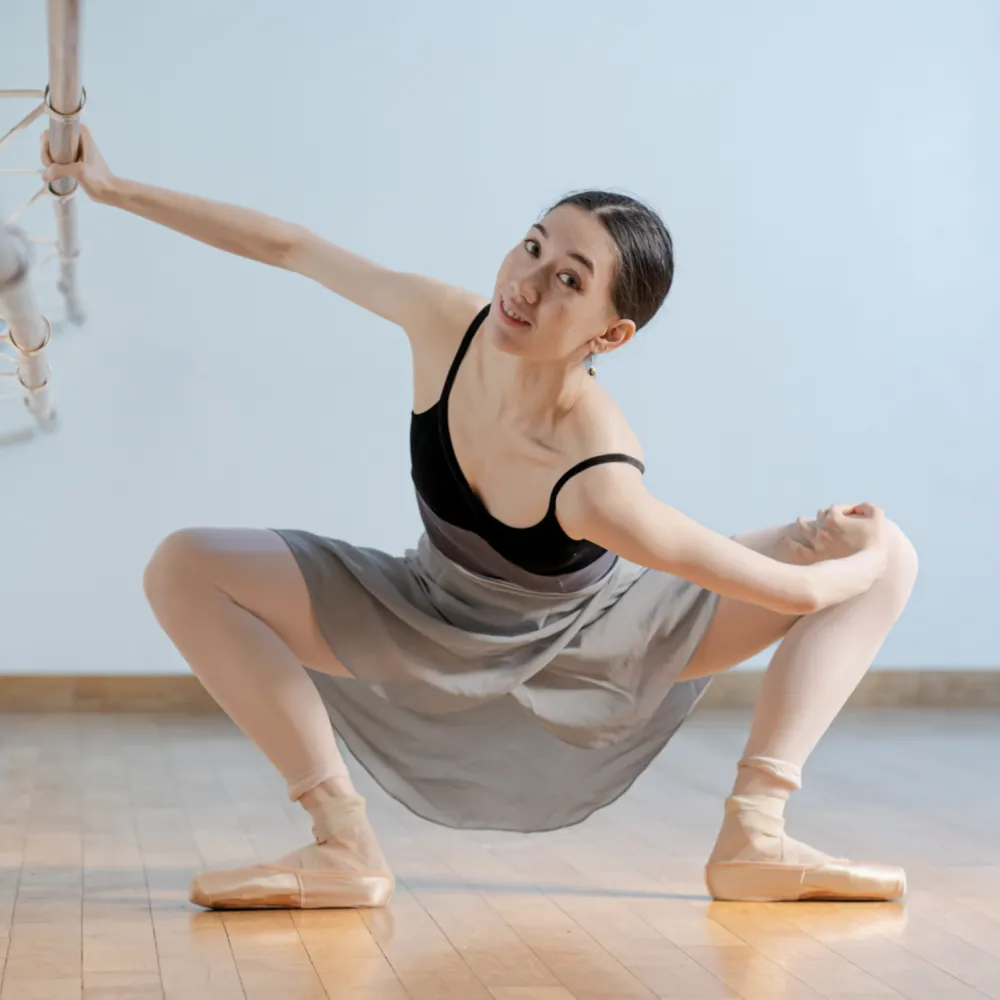 Photo of a dancer stretching low to the floor